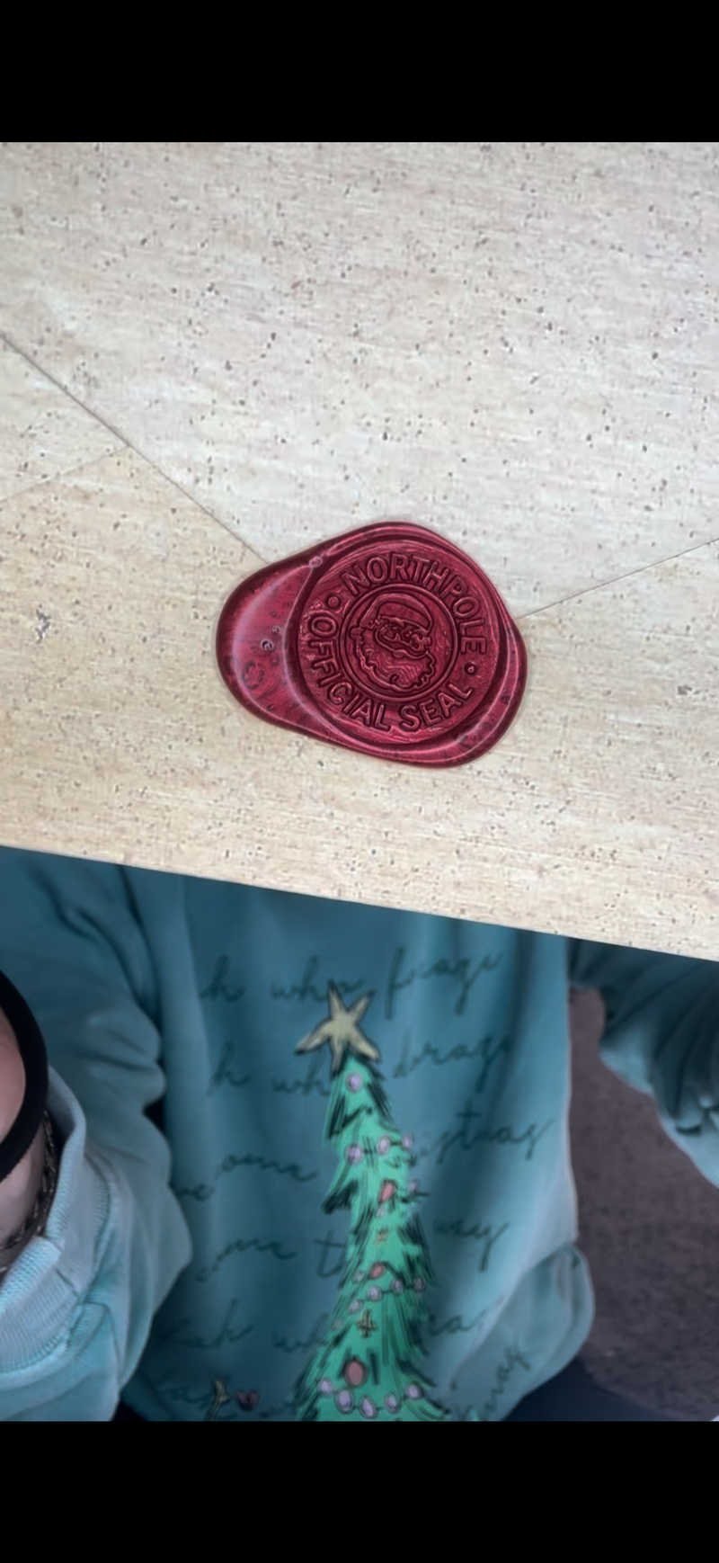 Red wax seal stamped with “North Pole Official Seal” on parchment-style envelope